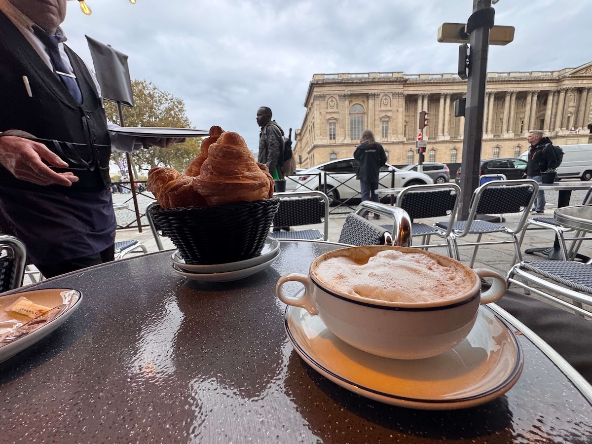 Having a coffee across from the Louvre in Paris